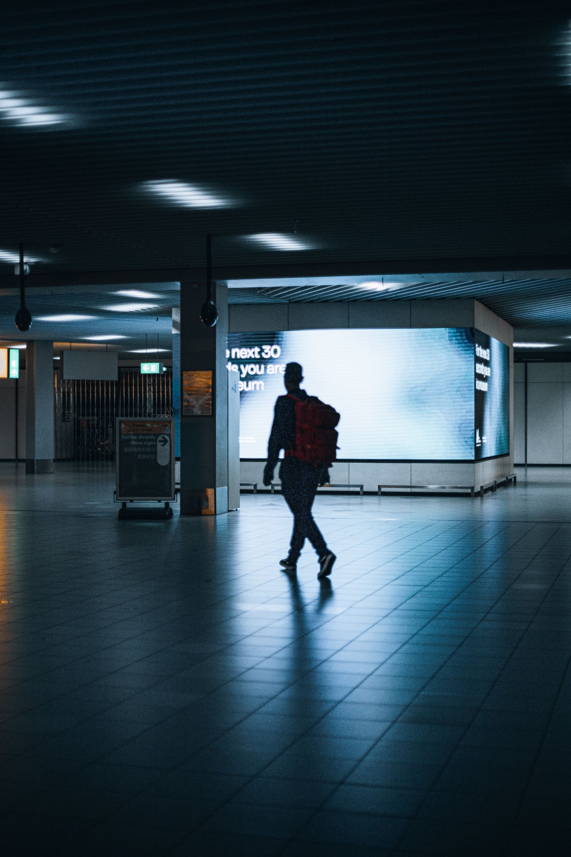 Someone walking down a dark corridor